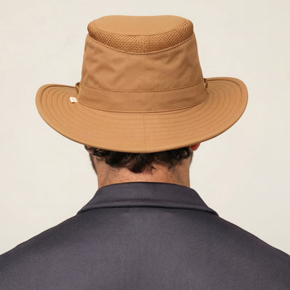 A person in a Tilley LTM5 Airflo® Hat and a dark collared shirt, seen from behind.