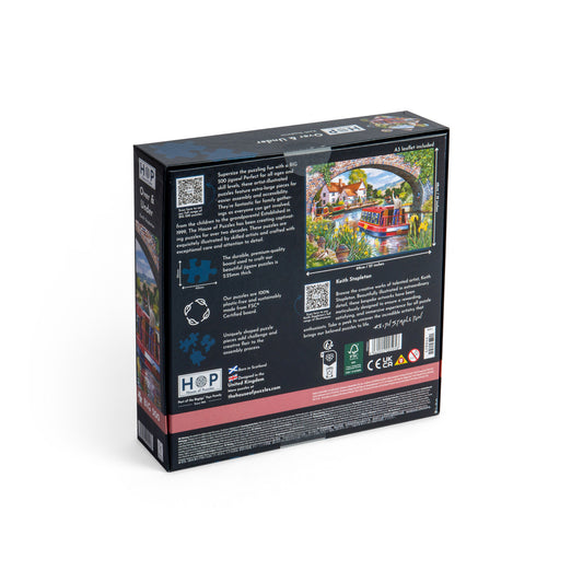 Product Image – Back of the House of Puzzles BIG 500 Piece Jigsaw Puzzle - Over & Under showing a red trolley crossing a stone bridge.