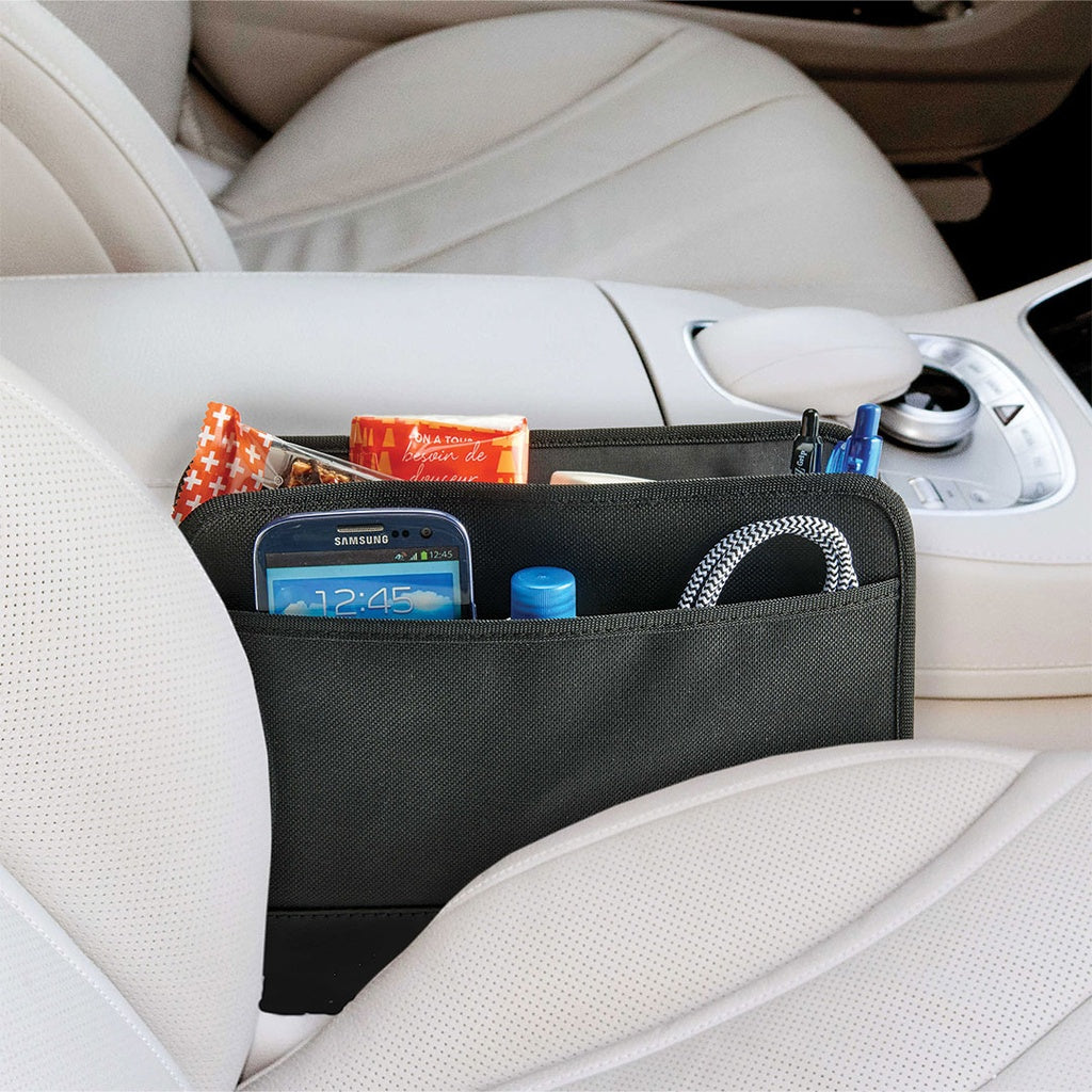 High Road GapStash™ Seat Gap Organizer holds phone, snacks, pens & cable on light leather between seats.