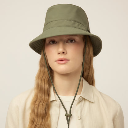 Person wearing a thyme green Tilley LTM1 Airflo® Bucket Hat with chin strap, facing forward.