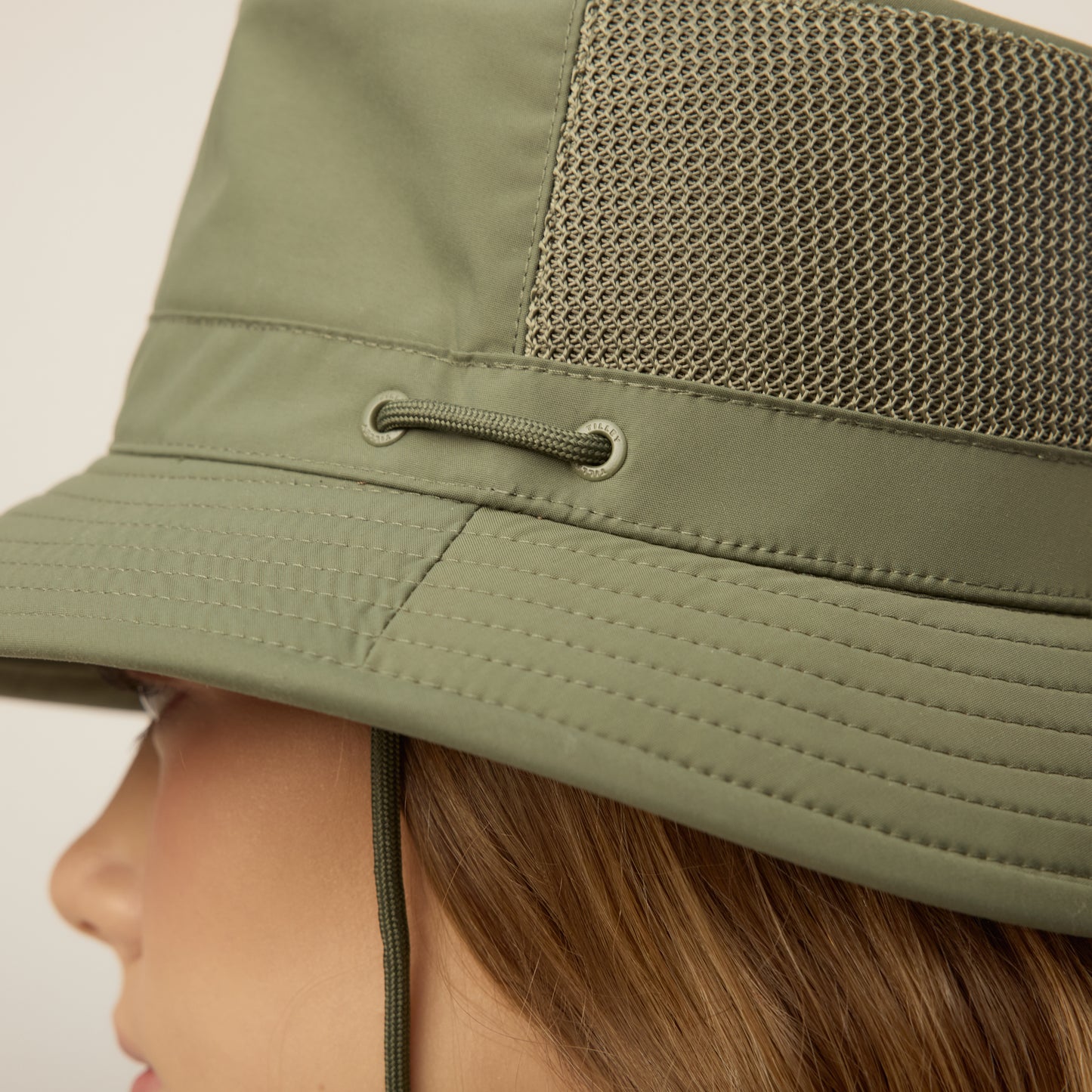 Close-up of the thyme green Tilley LTM1 Airflo® Bucket Hat with mesh panel and corded eyelet.