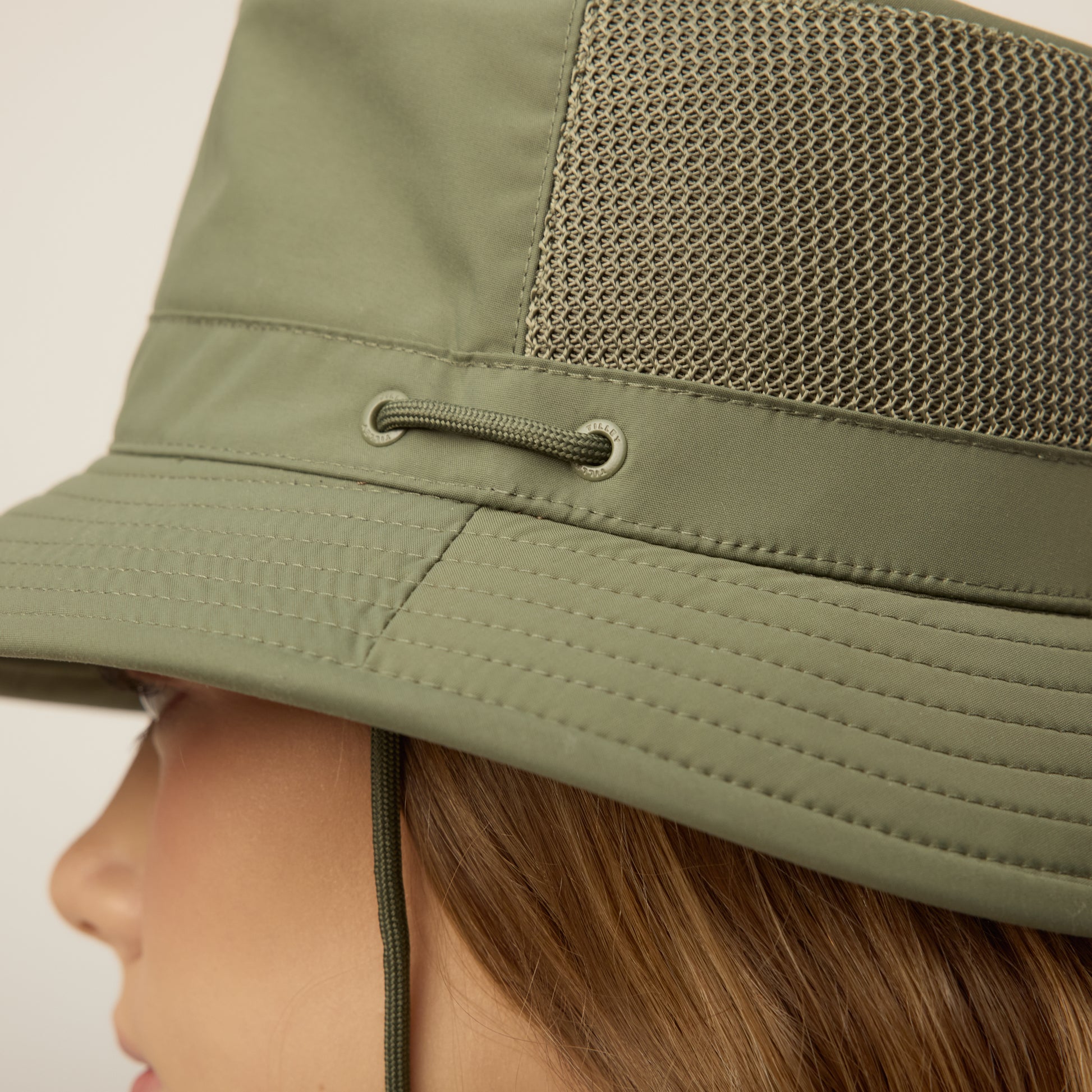 Close-up of the thyme green Tilley LTM1 Airflo® Bucket Hat with mesh panel and corded eyelet.
