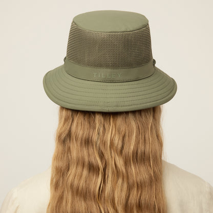 Person wearing a thyme green Tilley LTM1 Airflo® Bucket Hat with chin strap, back view.