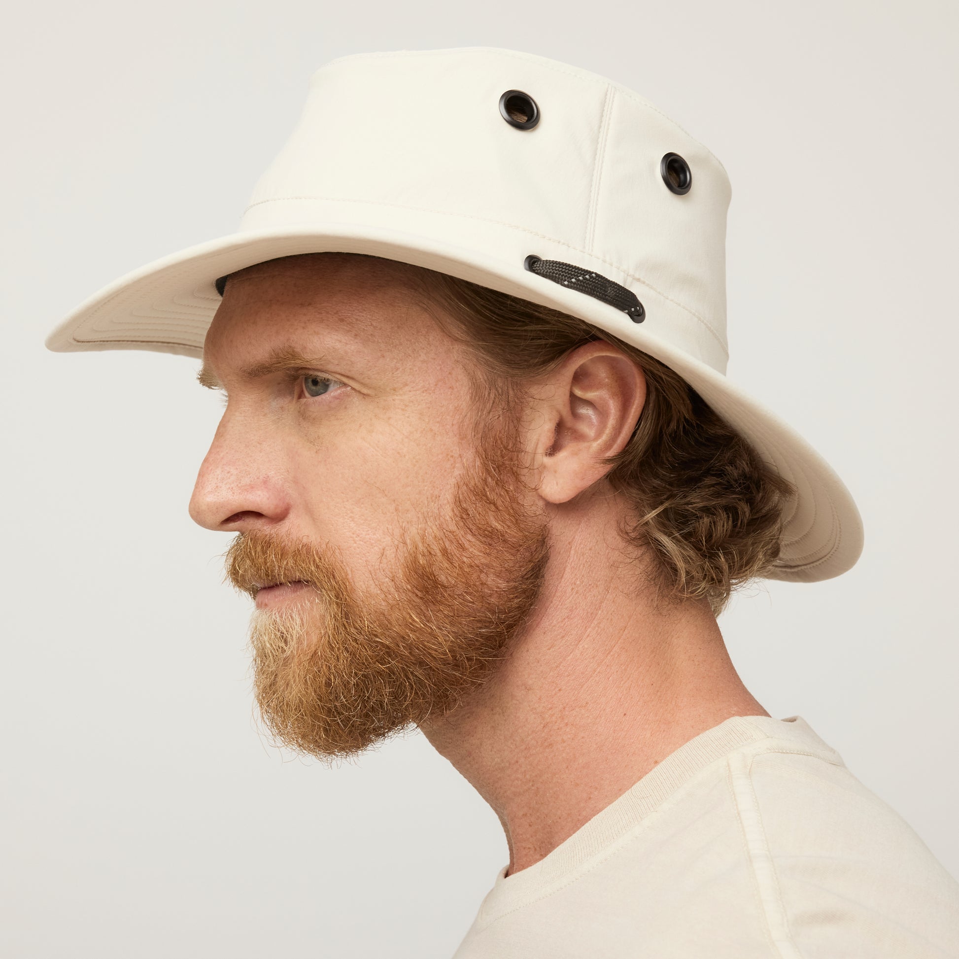 Man with a reddish beard in profile wears a Tilley T5 Adventure Ultralight Hat for UPF 50+ sun protection.