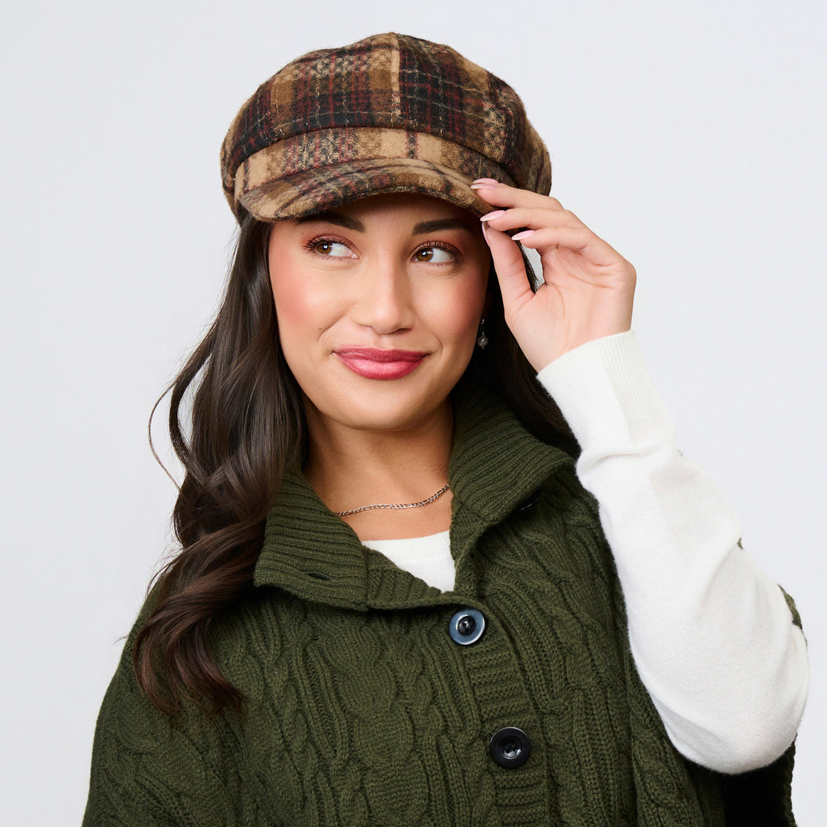 A person wearing a brown tartan plaid Howard’s Tartan Plaid Newsboy Hat.