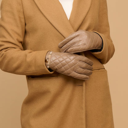 Howard’s Vivi Quilted Vegan Leather Gloves in taupe, paired with a tan coat.