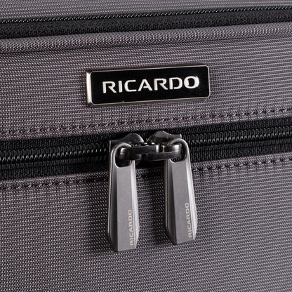 Close-up of Ricardo Beverly Hills Montecito 3.0 Softside Carry-on Spinner in gray with double zippers and logo above.