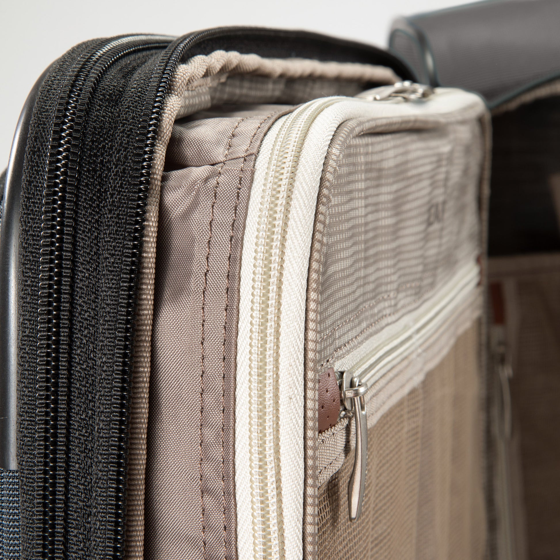 Close-up of the Ricardo Beverly Hills Montecito 3.0 carry-on with zipped compartments and mesh pockets.