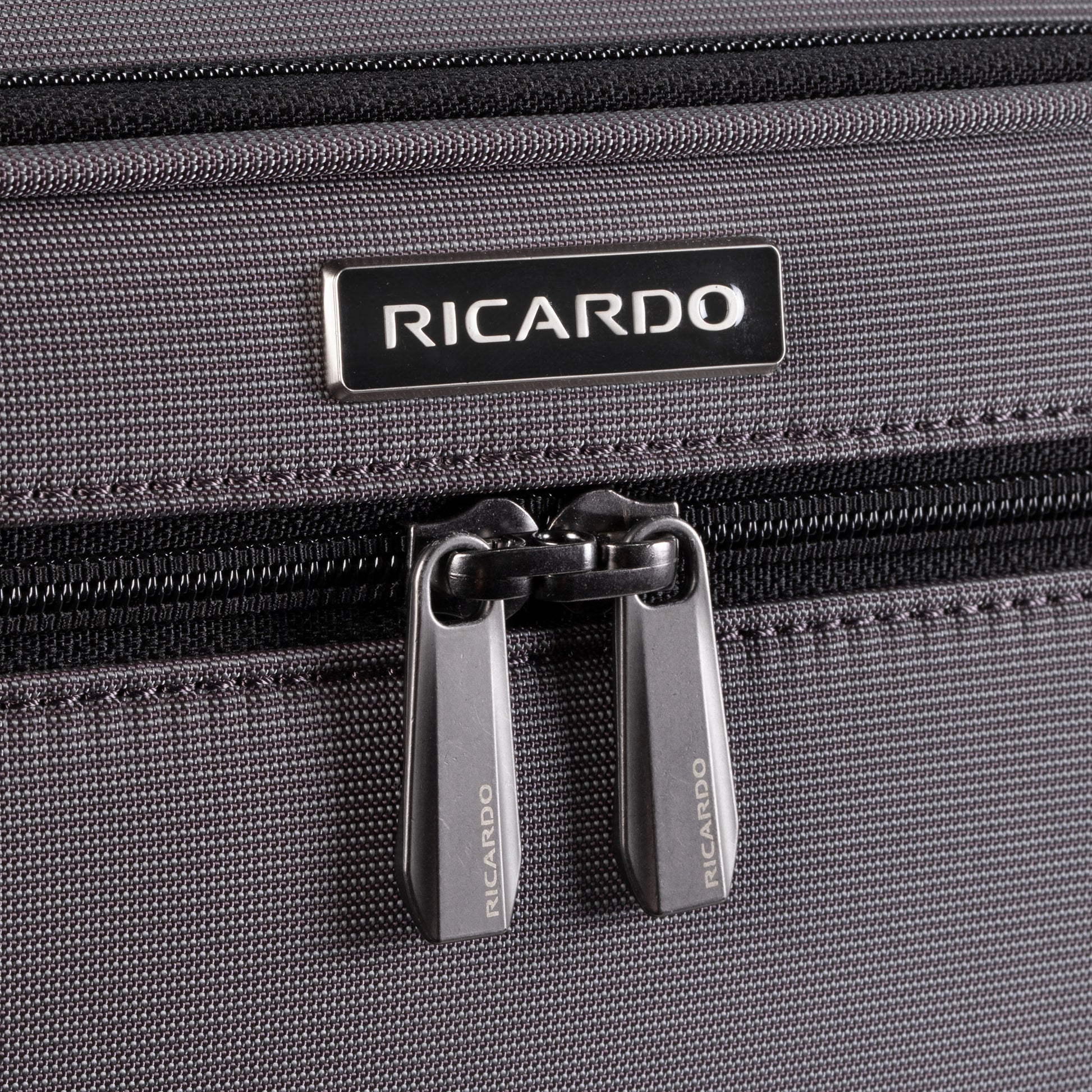 Close-up of the Ricardo Beverly Hills Montecito 3.0 medium softside spinner with dual zipper pulls.
