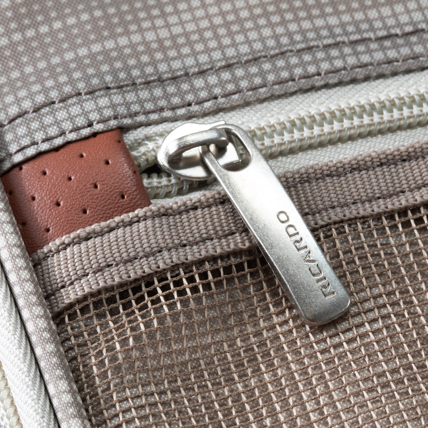 Close-up of a zippered pocket on Ricardo Beverly Hills Montecito 3.0 Softside Medium Check-In Spinner luggage.