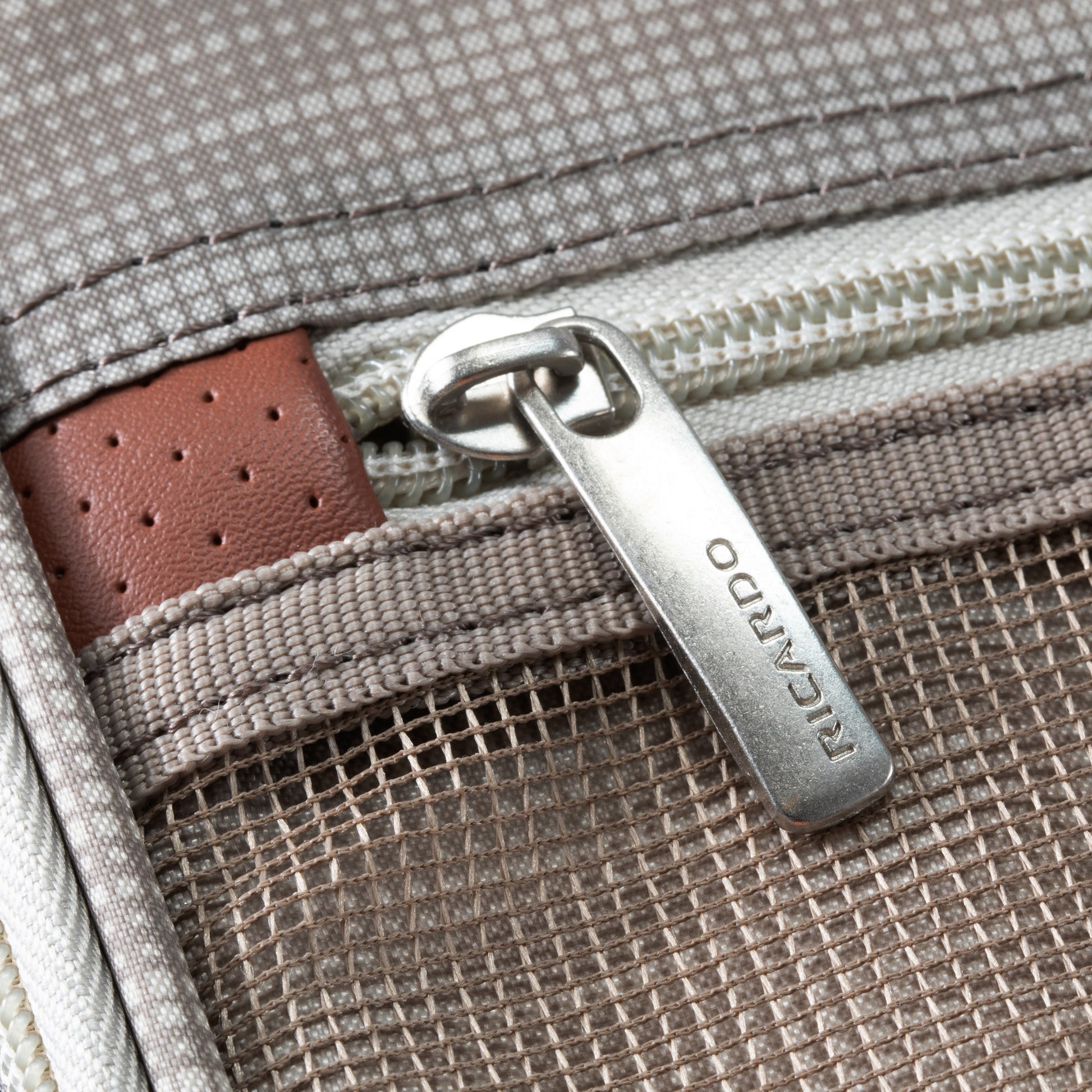 Close-up of a zippered pocket on the Ricardo Beverly Hills Montecito 3.0 Large Expandable Spinner suitcase.