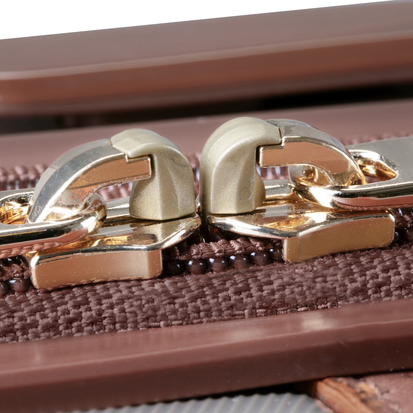 Close-up of gold zipper pulls on the Ricardo Beverly Hills Montecito 2.0 21" Carry-on with TSA lock.