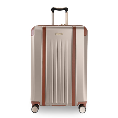 Ricardo Beverly Hills Montecito 2.0 25" beige hardside spinner with brown accents and telescoping handle, upright.