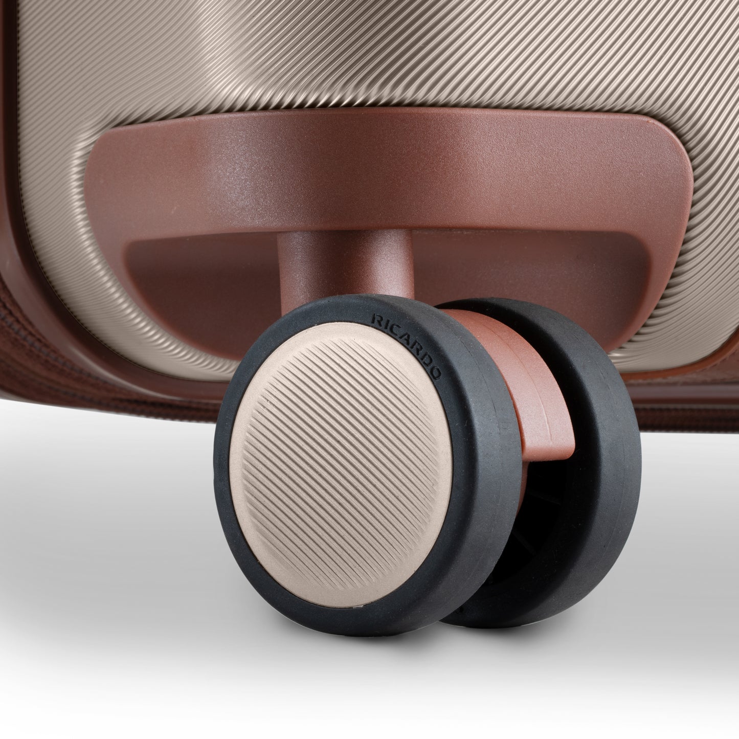 Close-up of Ricardo Beverly Hills Montecito 2.0 25" hardside spinner wheel with textured surface and branding.