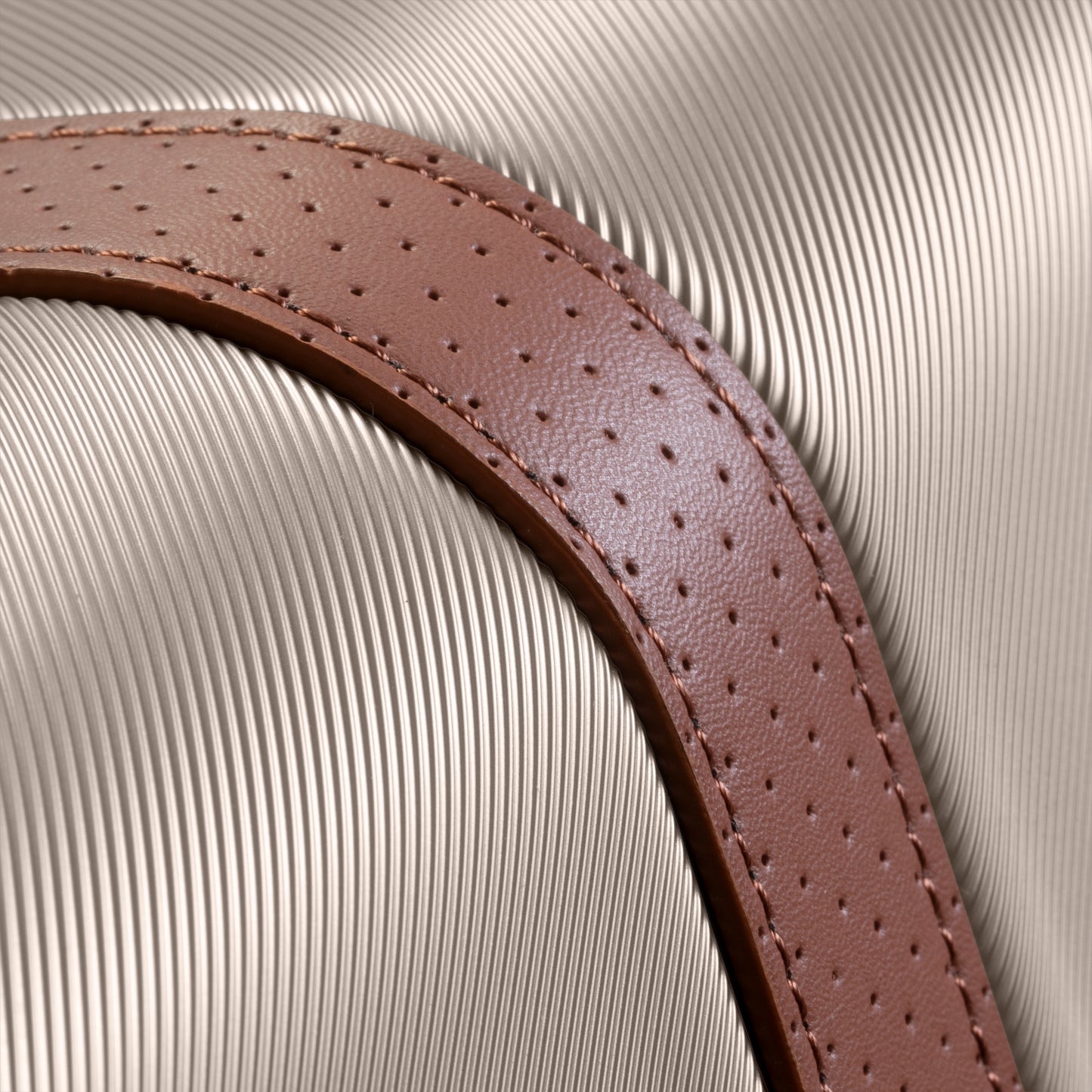 Textured brown leather strap on Ricardo Beverly Hills Montecito 2.0 hardside spinner with ribbed silver shell.