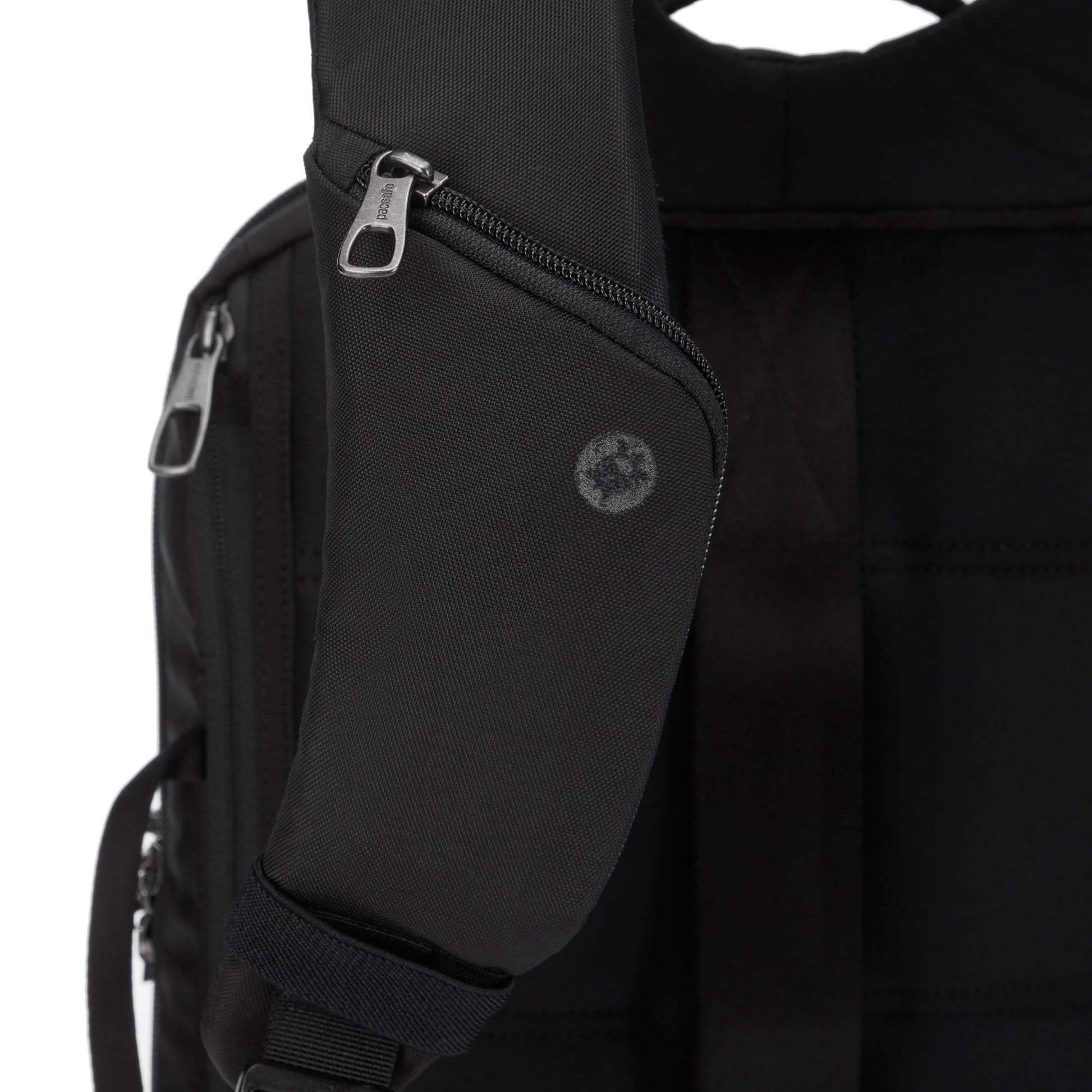 Close up of small pocket on one shoulder strap of the black 
Pacsafe® X Anti-Theft 13-Inch Commuter Backpack