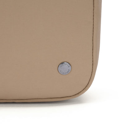 Close-up of Pacsafe® CX Anti-theft Square Crossbody’s corner with round metal logo, made from ECONYL nylon.