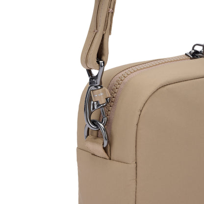 Close-up of the Pacsafe® CX Anti-theft Square Crossbody, beige ECONYL nylon bag with metal clasp and strap.