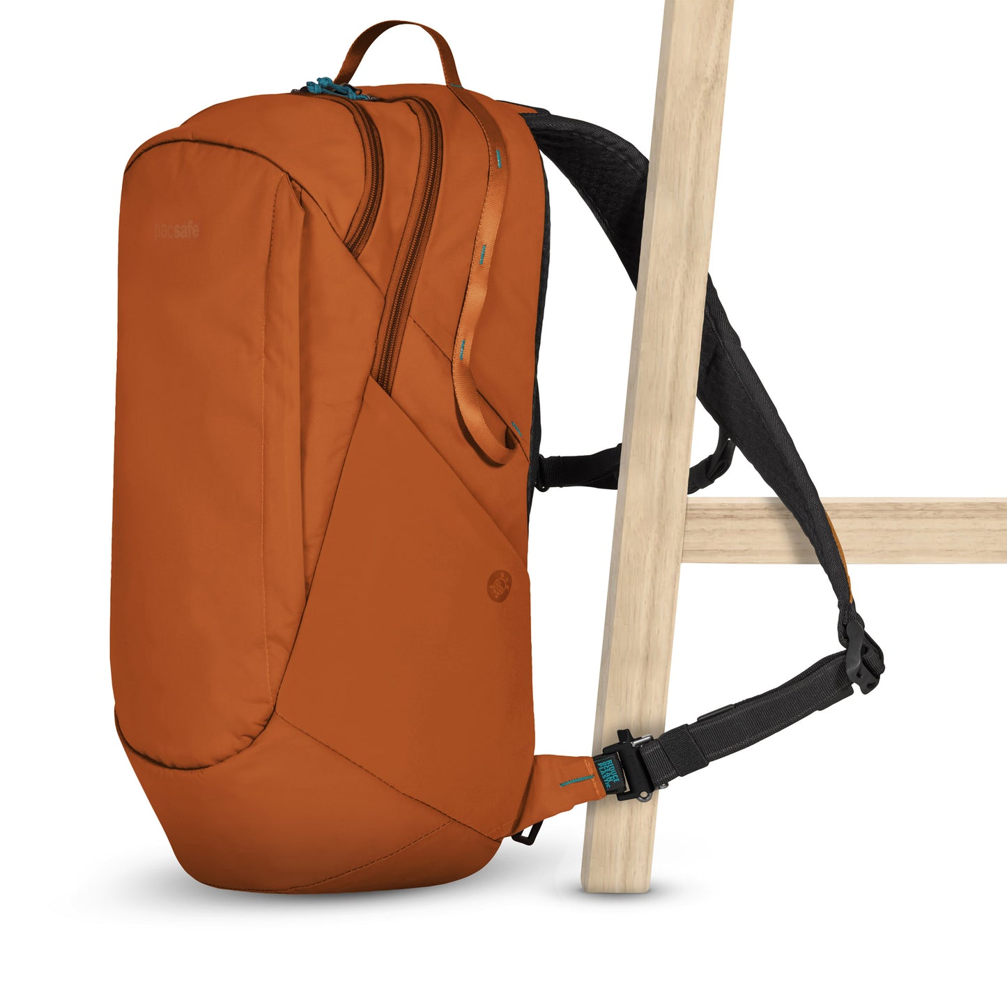 Pacsafe® ECO 25L Anti-theft Backpack, canyon orange colour with black straps, with one strap secured to a chair leg