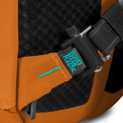 Close up of security clip on one shoulder strap of canyon Pacsafe® ECO 25L Anti-theft Backpack