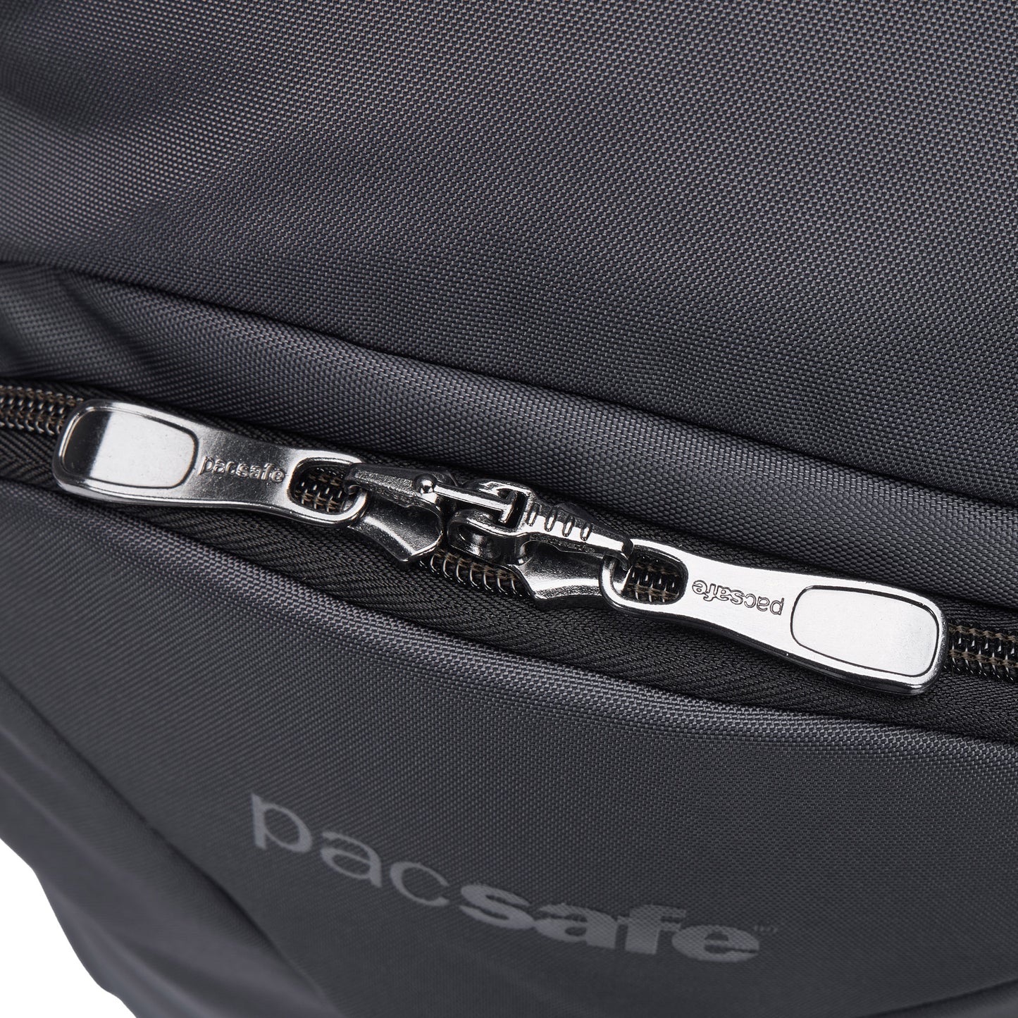 Close-up of Pacsafe® EXP 28L Anti-Theft Backpack showing dual interlocked zippers and Pacsafe branding below.