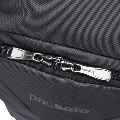 Close-up of Pacsafe® EXP 28L Anti-Theft Backpack showing dual interlocked zippers and Pacsafe branding below.
