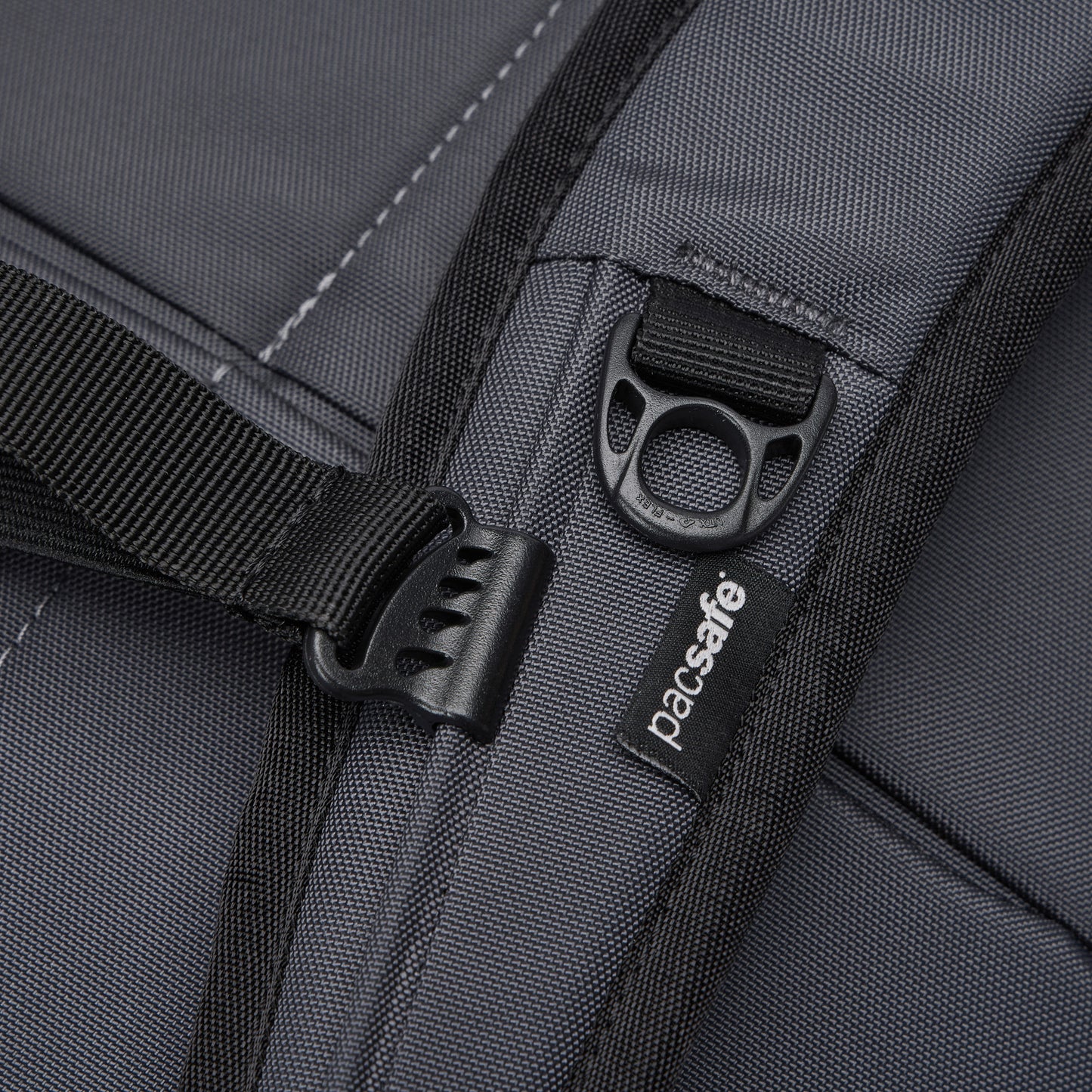 Close-up of the Pacsafe® EXP 28L Anti-Theft Backpack showing strap, zipper, and Pacsafe branding.