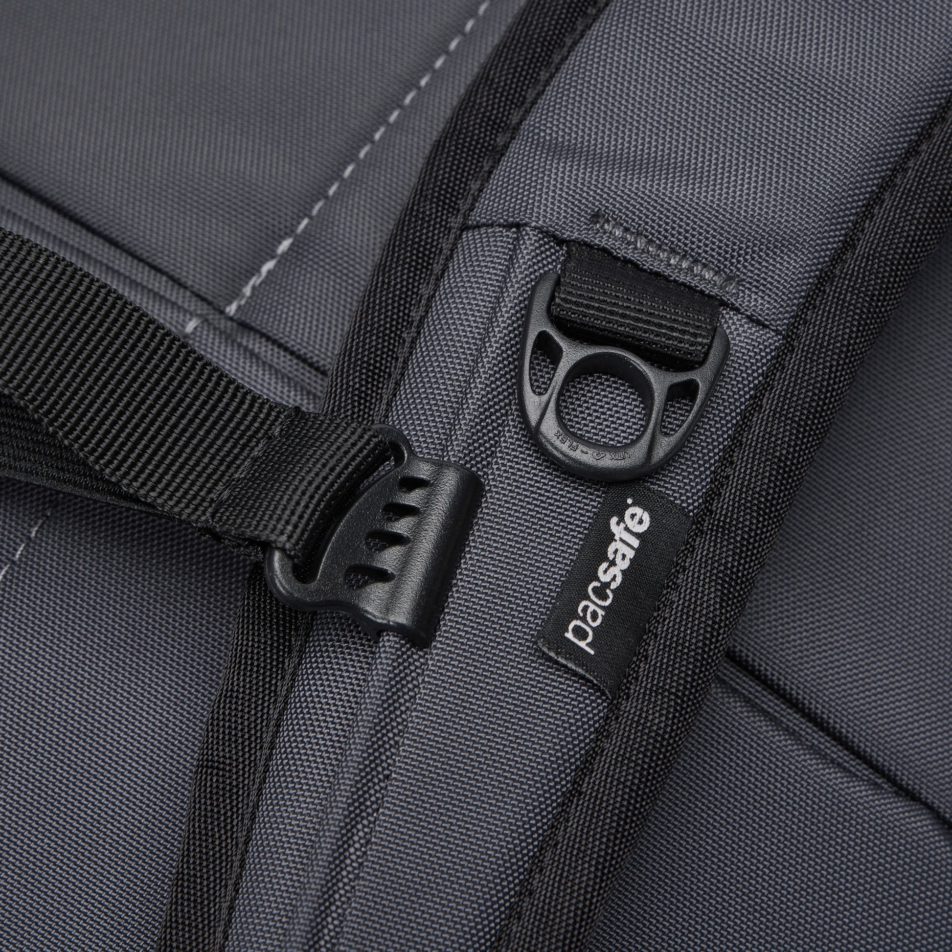 Close-up of the Pacsafe® EXP 28L Anti-Theft Backpack showing strap, zipper, and Pacsafe branding.