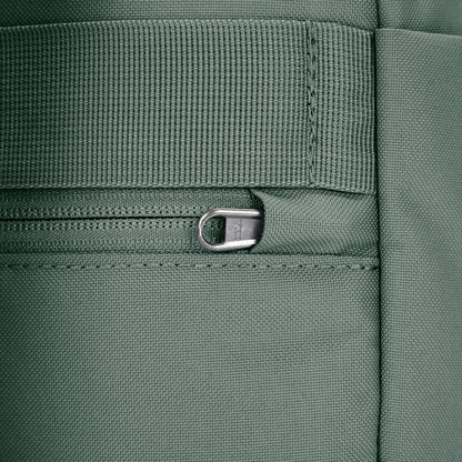Close up of tucked zipper pull security feature on spruce green backpack