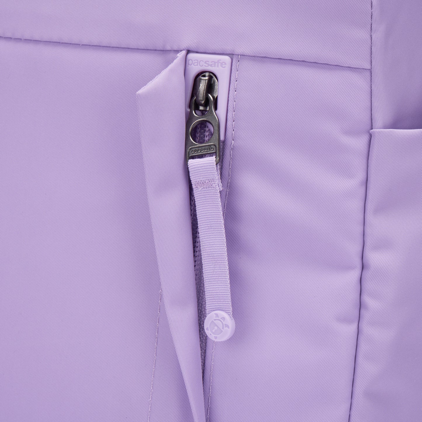 Close-up of Pacsafe® GO 15L Anti-theft Backpack with secure zippers and RFID blocking pocket.