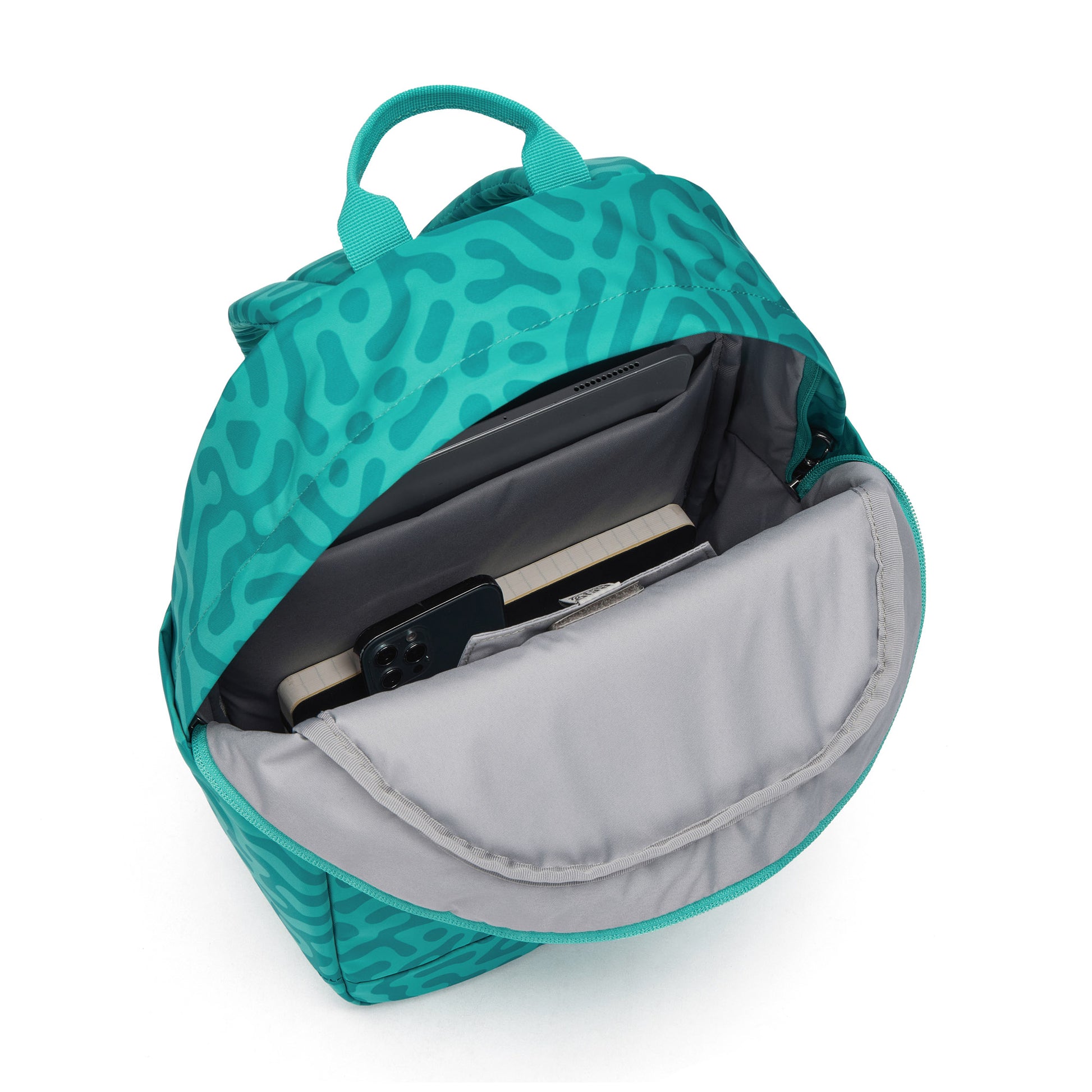 Pacsafe GO 15L backpack in reef green abstract print, open view.