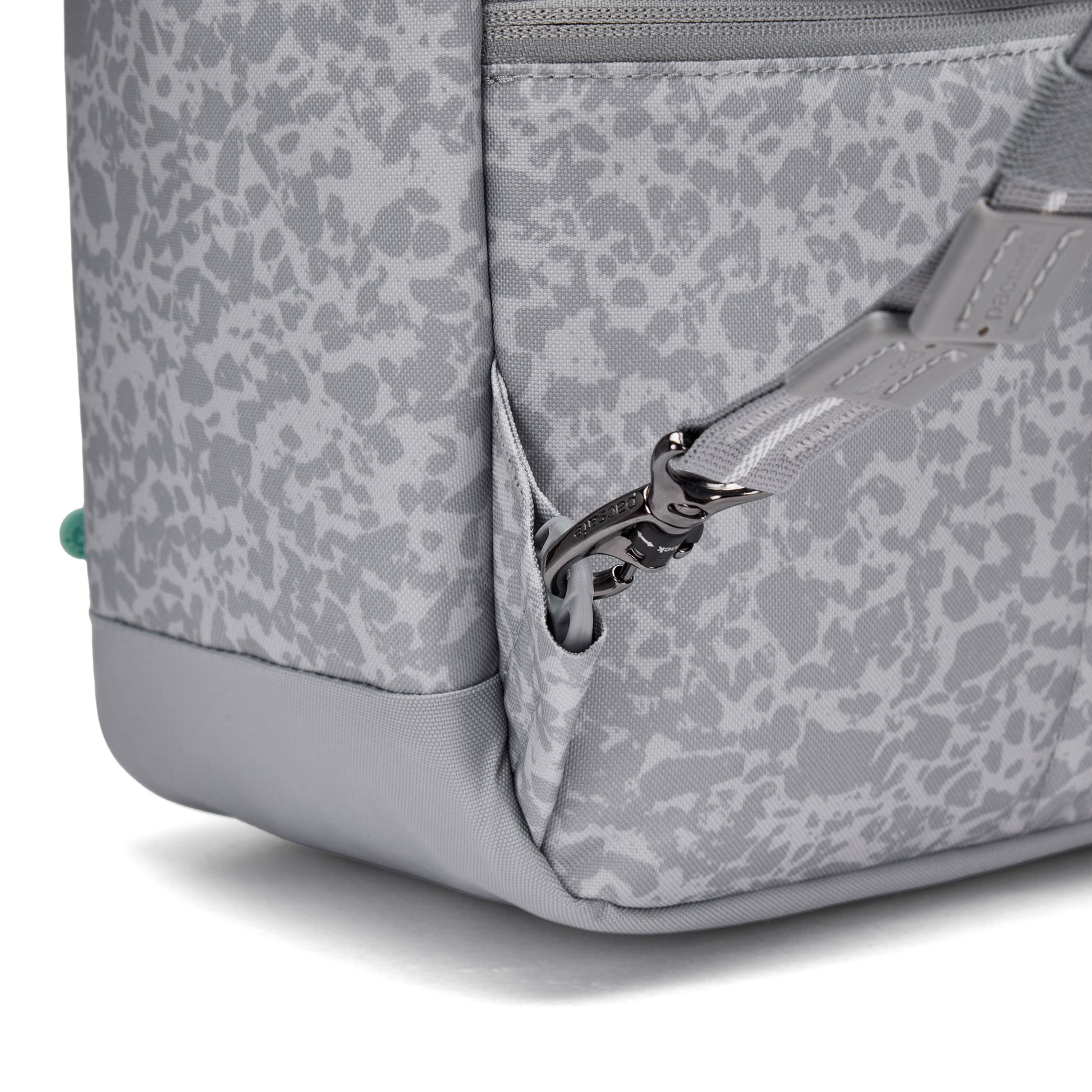 Close-up of the Pacsafe® GO 15L Anti-theft Backpack showing strap, RFID detail, and front pocket.