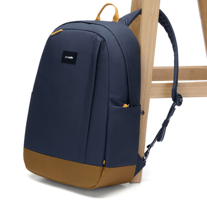 Pacsafe® GO 25L Anti-theft Backpack, coastal blue, attached to wooden chair leg.