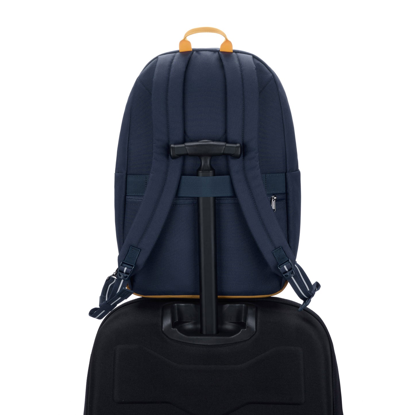 Pacsafe® Go 25L Anti-theft Backpack, coastal blue, back view sitting on top of a black luggage with handle through back strap