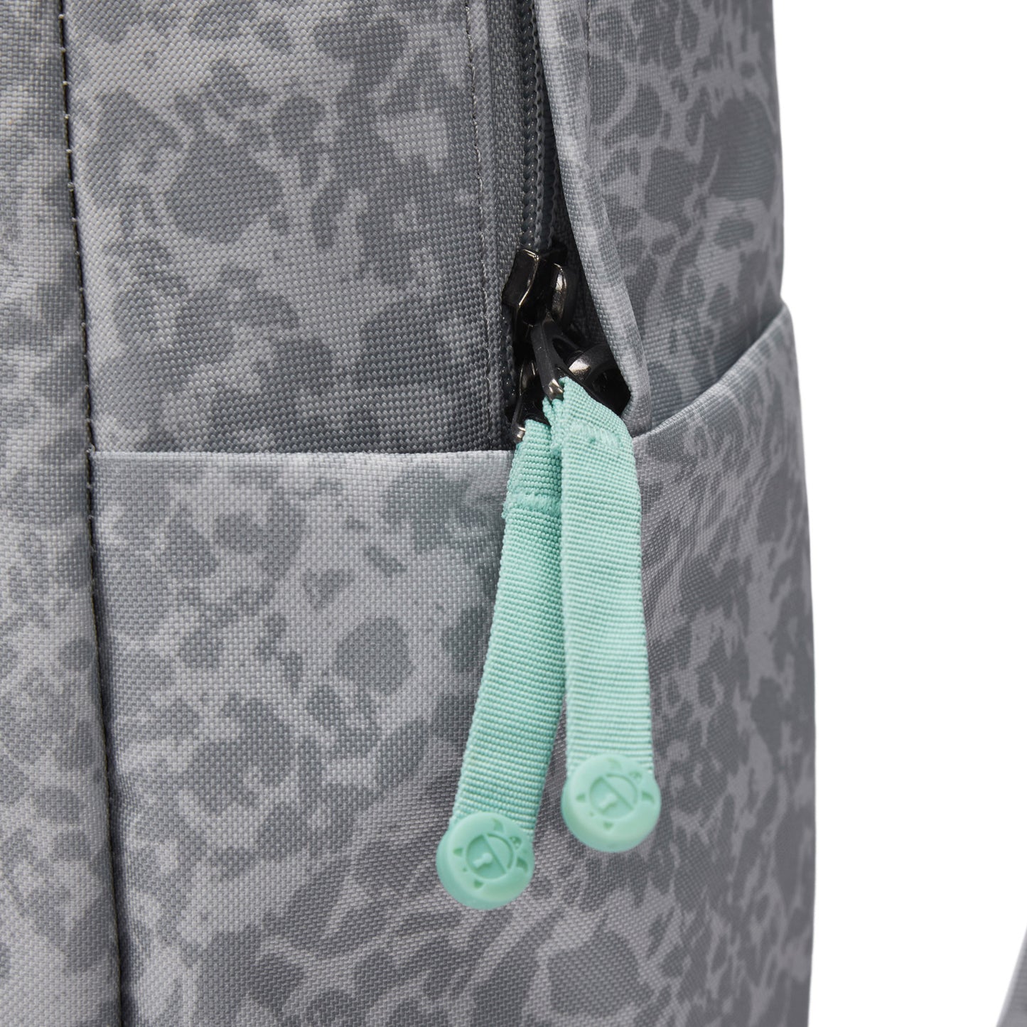 Close-up of Pacsafe® GO 25L Anti-theft Backpack in gray with mint green zipper pulls and side pocket.