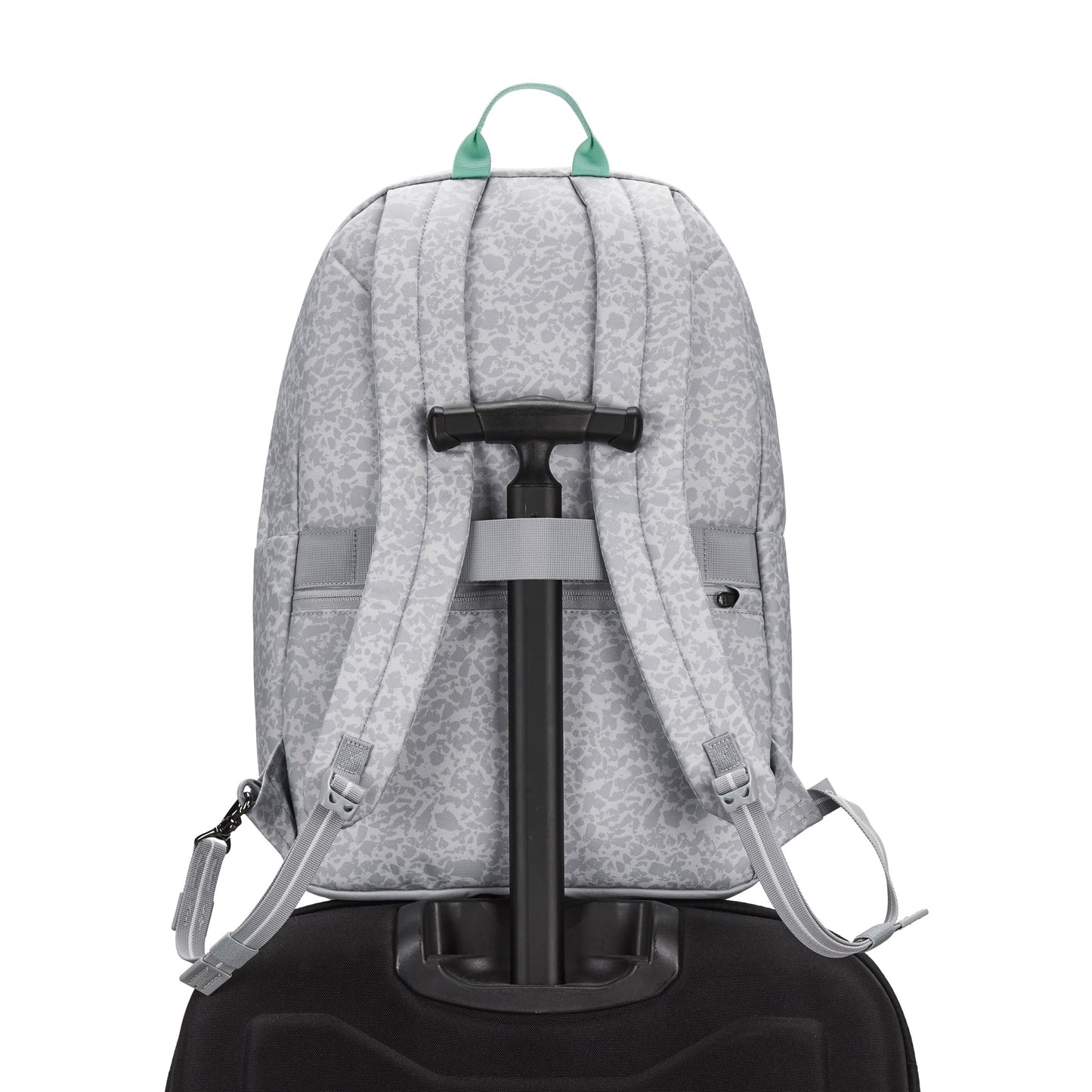 Pacsafe® GO 25L Anti-theft Backpack in gray sits on a black suitcase, viewed from the back.