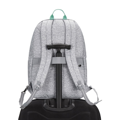 Pacsafe® GO 25L Anti-theft Backpack in gray sits on a black suitcase, viewed from the back.