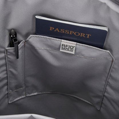 A navy passport and pen in the RFID pocket of a Pacsafe® GO 25L Anti-theft Backpack by Pacsafe.