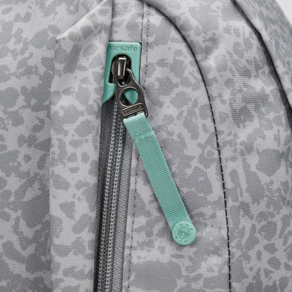 Close-up of a gray Pacsafe® GO 25L Anti-theft Backpack with mint green zipper pull and visible Pacsafe tag.