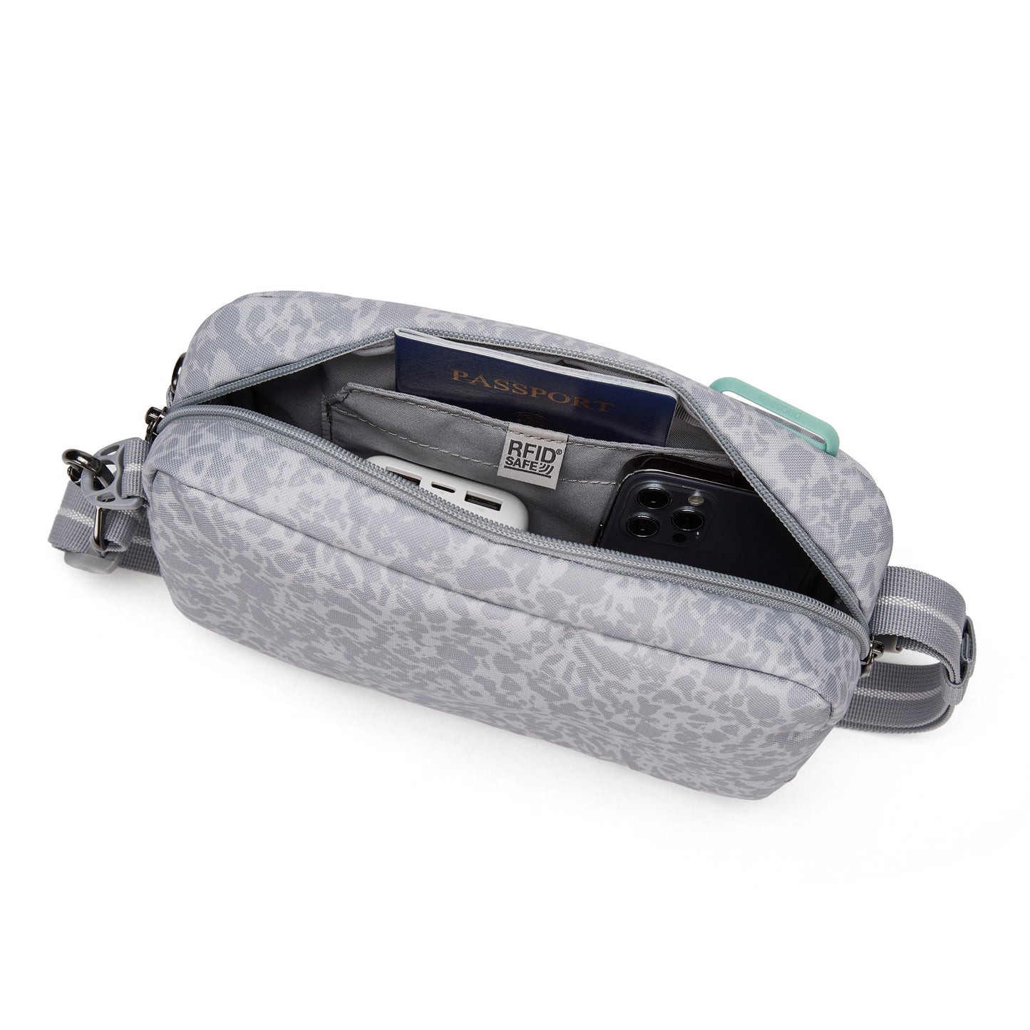 Pacsafe® GO Anti-Theft Crossbody Bag open to display passport, phone, cards & wallet inside.