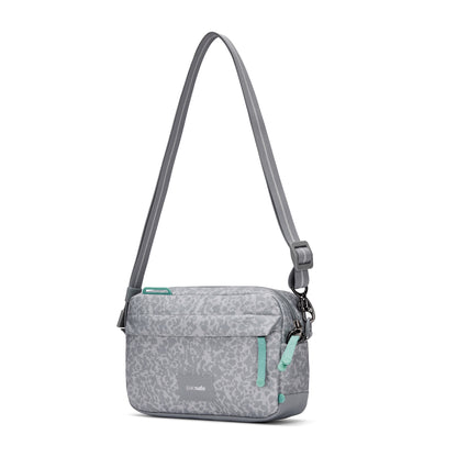Pacsafe® GO Anti-Theft Crossbody Bag by Pacsafe; gray with animal print, teal zips & RFID blocking pocket.
