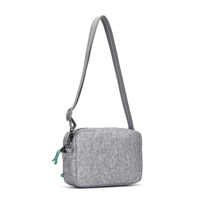 Pacsafe® GO Anti-Theft Crossbody Bag in light gray recycled polyester with abstract pattern, adjustable strap.