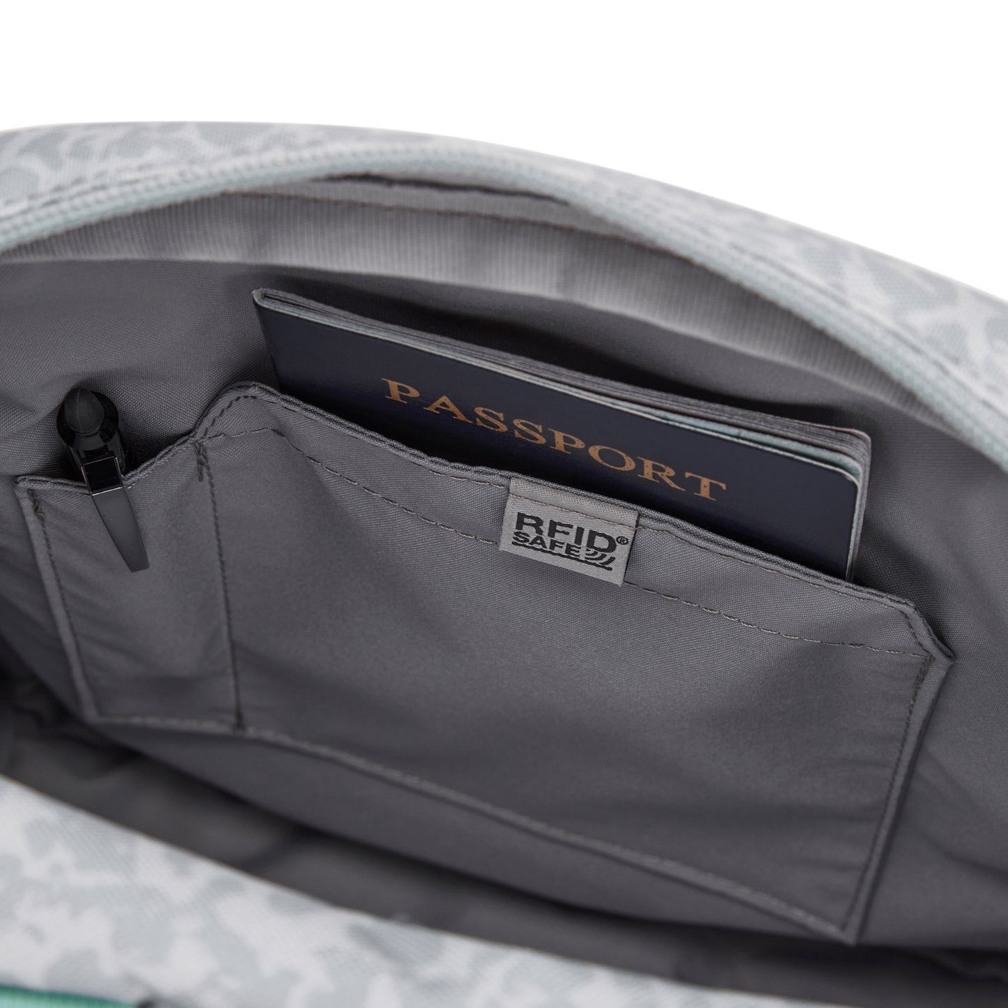 Close-up of Pacsafe® GO Anti-Theft Crossbody Bag with RFID pocket, holding a passport and RFID Safe pouch.
