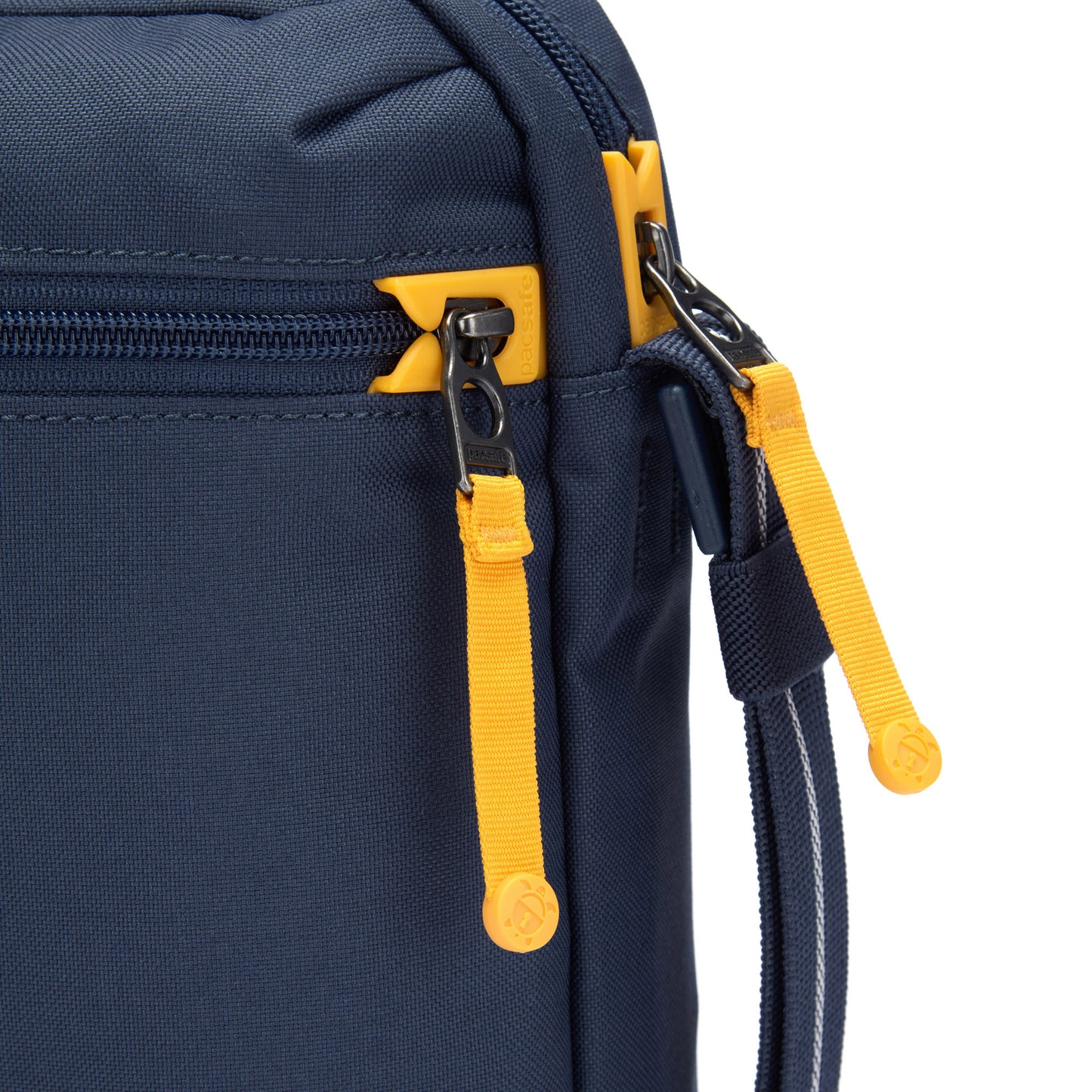 Close up of yellow zipper pulls and lockable zippers on the coastal blue Pacsafe® GO Anti-Theft Festival Crossbody