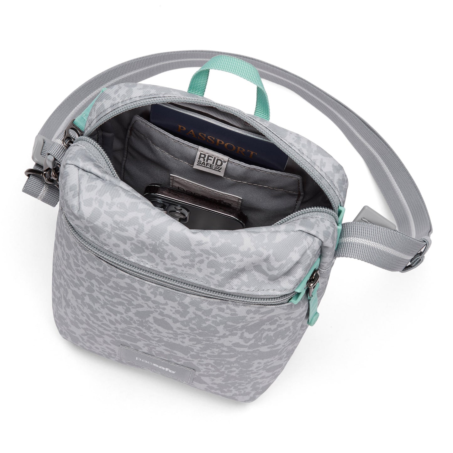 Pacsafe® GO Anti-Theft Festival Crossbody with RFID pocket holds passport & phone; top-down view.