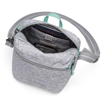 Pacsafe® GO Anti-Theft Festival Crossbody with RFID pocket holds passport & phone; top-down view.