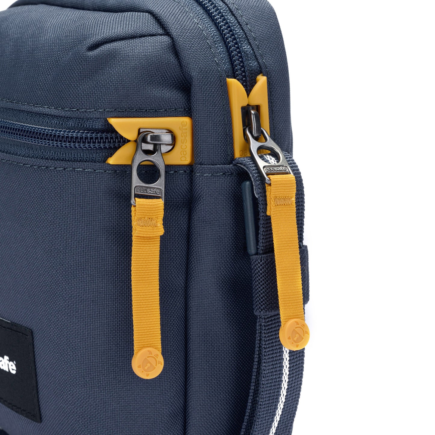 Close-up of the Pacsafe® GO Anti-Theft Micro Crossbody in blue with yellow zippers, made from recycled polyester.