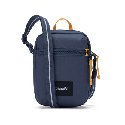 The Pacsafe® GO Anti-Theft Micro Crossbody is blue, small, with yellow zippers and a black adjustable strap.
