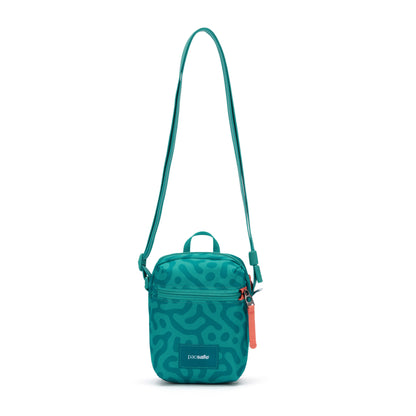 Pacsafe® GO Anti-Theft Micro Crossbody by Pacsafe: teal, abstract pattern, RFID pocket, adjustable strap.
