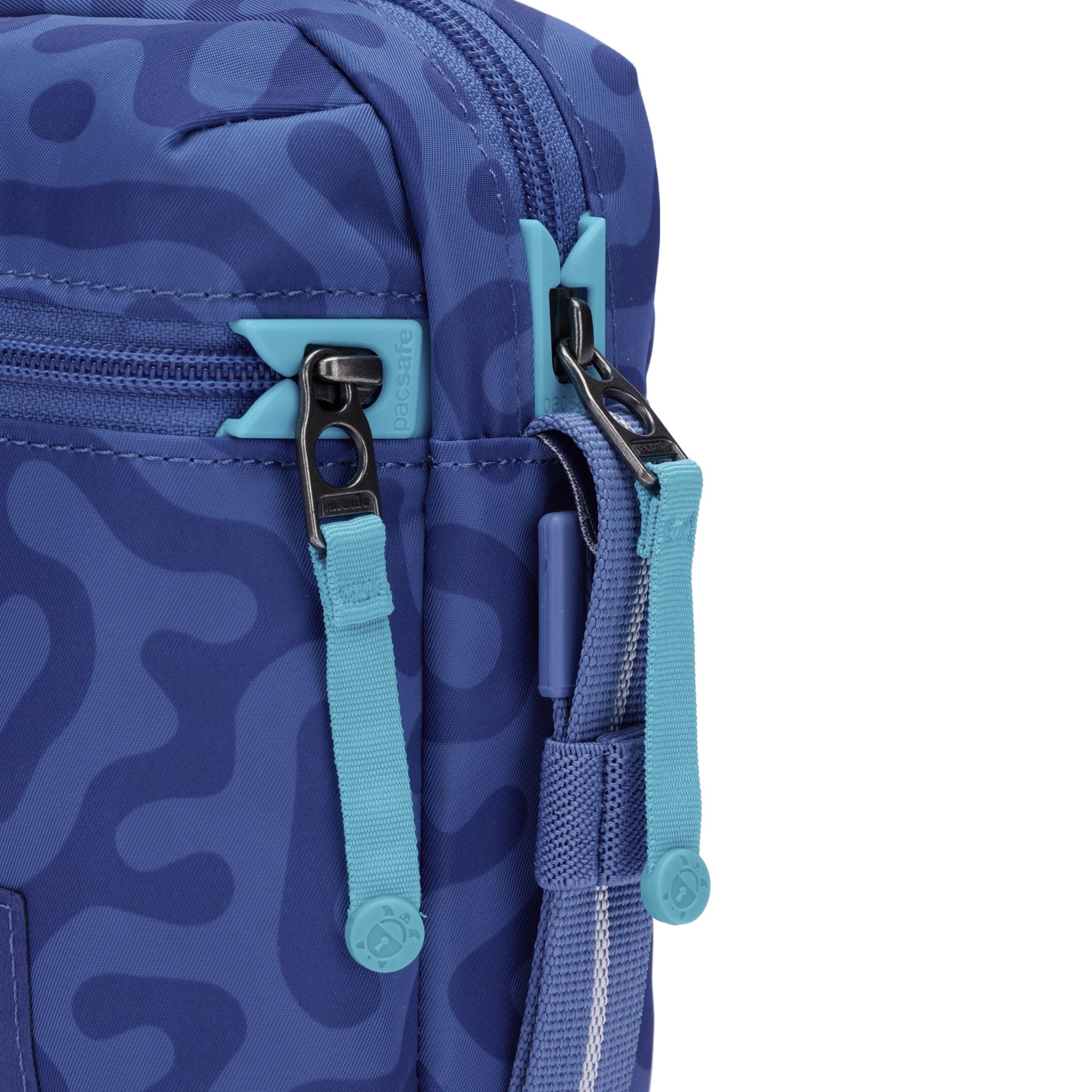 A close-up of the Pacsafe® GO Anti-Theft Micro Crossbody in blue, made from recycled polyester.